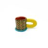 patterned ceramic cup in green with large yellow handle and blue foot from Rebu Ceramics