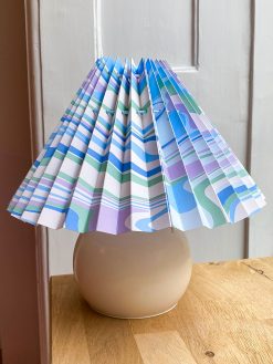 Light blue lampshade with pattern. The lampshade is from Shady Business who produces and folds their products in Denmark from environmentally friendly paper.