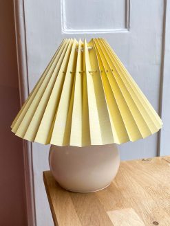Light yellow lampshade with thin stripes. The lampshade is from Shady Business who produces and folds their products in Denmark from environmentally friendly paper.