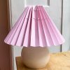 Pink lampshade with thin stripes . The lampshade is from Shady Business who produces and folds their products in Denmark from environmentally friendly paper.