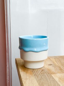 Cup with light blue glaze running.