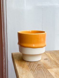 Cup with light orange runny glaze