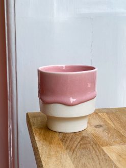 Cup with runny pink glaze.